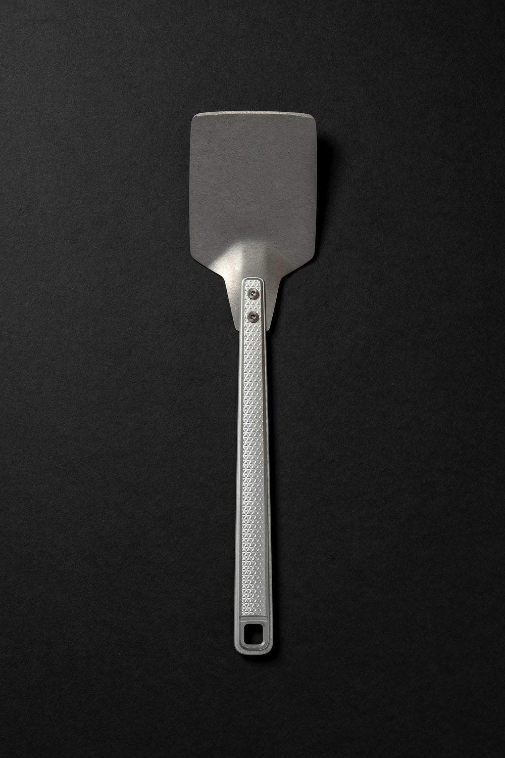 silver millrite spatula on black background